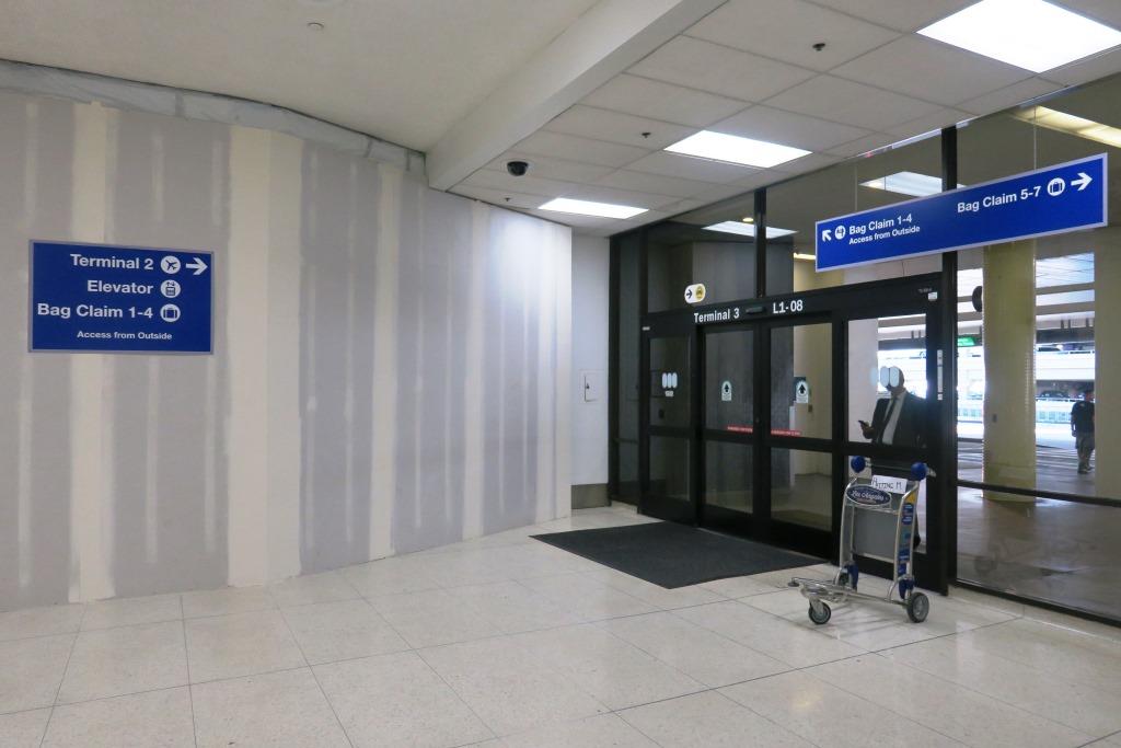 The connector between the Terminal 2 and Terminal 3 baggage claim areas is closed as work takes place on Delta Air Lines' $1.9-billion renovation. Guests are detoured to the sidewalk.