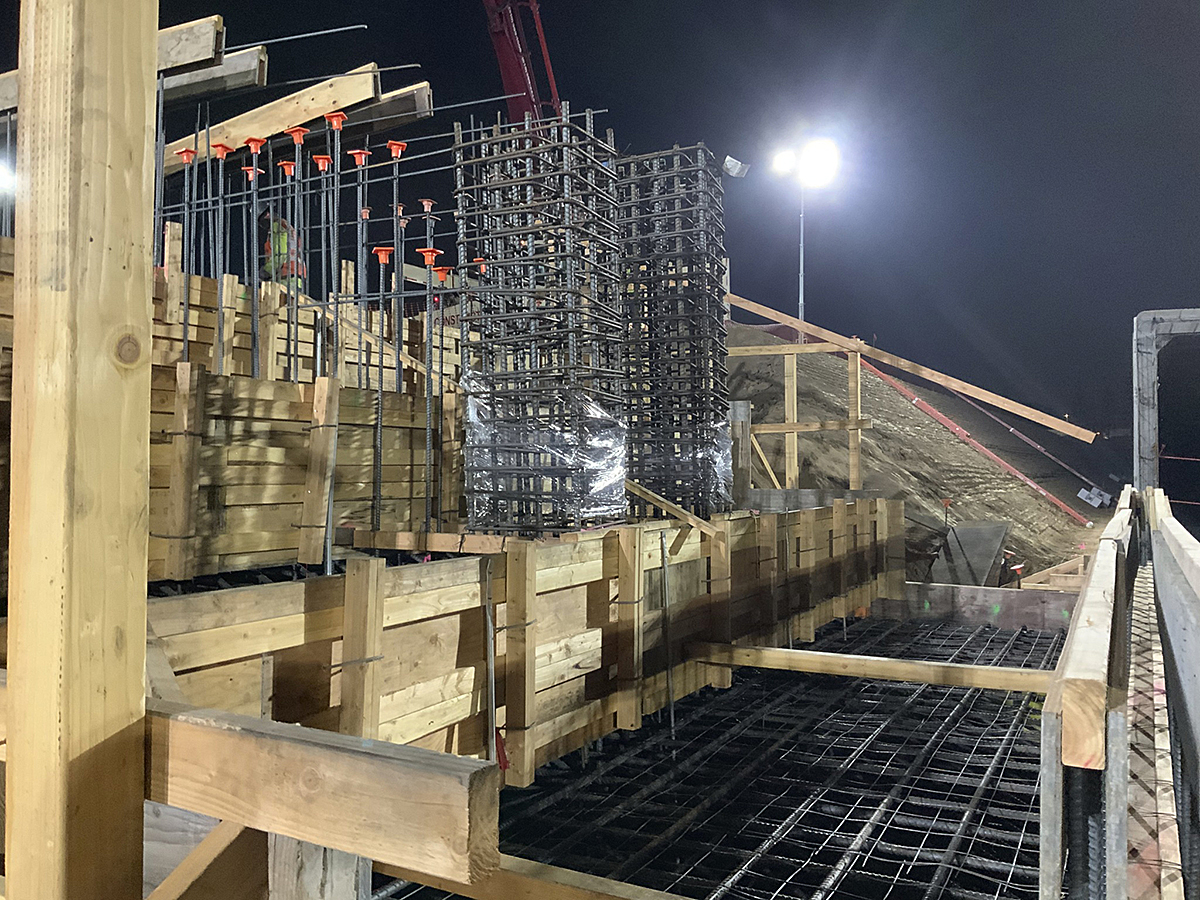 Workers pouring concrete for the foundation structures at the Consolidated Rent-A-Car Facility