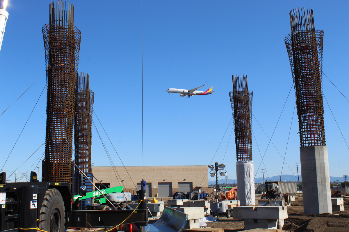 Guideway columns are under construction along the Automated People Mover alignment