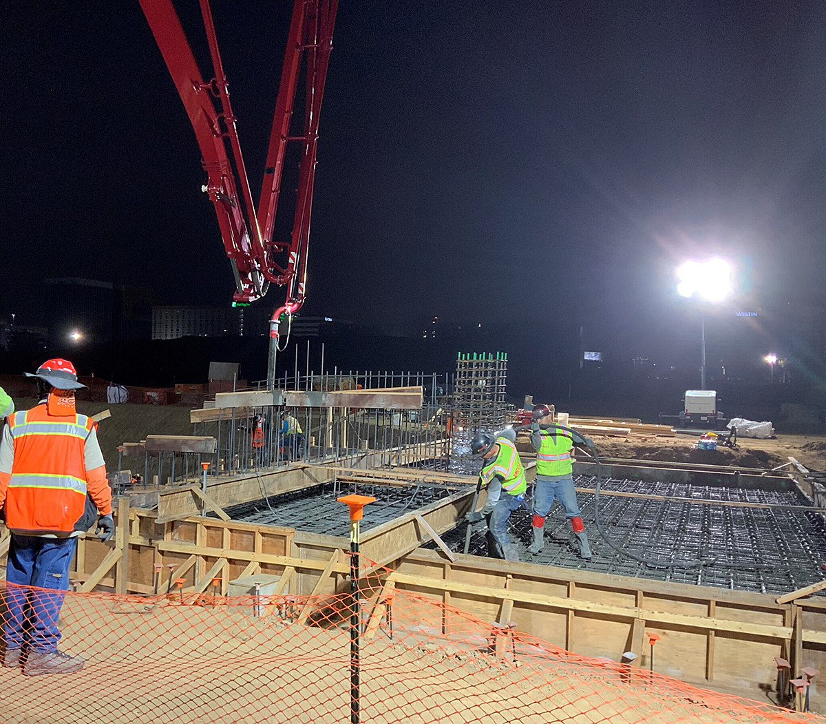 Workers pouring concrete for the foundation structures at the Consolidated Rent-A-Car Facility